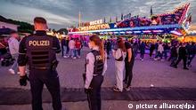 Police officers at a funfair in Lüdenscheid, western Germany, after a fatal shooting on May 21, 2022.