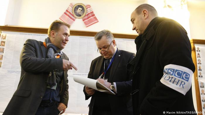 OSCE observers visit a polling station during snap elections for Ukraine s new parliament in 2014