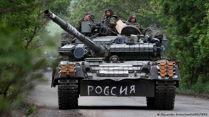 Service members of pro-Russian troops drive a tank during Ukraine-Russia conflict