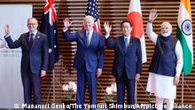 Leaders of Quad countries stand side-by-side and wave in Tokyo, Japan