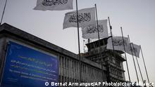 FILE - Taliban flags fly at the airport in Kabul, Afghanistan, Sept. 9, 2021. The Taliban announced a deal Tuesday, May 24, 2022, allowing the Abu Dhabi-based firm GAAC Solutions to manage the airports in Herat, Kabul and Kandahar. However, the United Arab Emirates did not immediately acknowledge the deal. (AP Photo/Bernat Armangue, File)