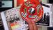A hand holding Neo-Nazi propaganda, including a CD A hand holding Neo-Nazi propaganda, including a CD