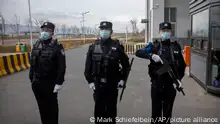 FILE - Police officers stand at the outer entrance of the Urumqi No. 3 Detention Center in Dabancheng in western China's Xinjiang Uyghur Autonomous Region on April 23, 2021. State officials took AP journalists on a tour of a training center turned detention site in Dabancheng sprawling over 220 acres and estimated to hold at least 10,000 prisoners - making it by far the largest detention center in China and among the largest on the planet. (AP Photo/Mark Schiefelbein, File)