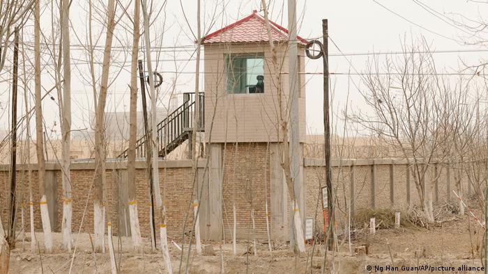 A security person watches from a guard tower at a detention facility in Xinjiang