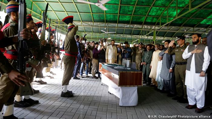 Senior police officers and others attend funeral prayers for a policeman who was killed by an opposition party supporter