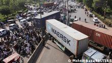 Vehicles with the shipping containers are parked to block the roads, ahead of the planned protest march towards Islamabad by ousted Prime Minister Imran Khan, in Lahore, Pakistan May 24, 2022. REUTERS/Mohsin Raza
