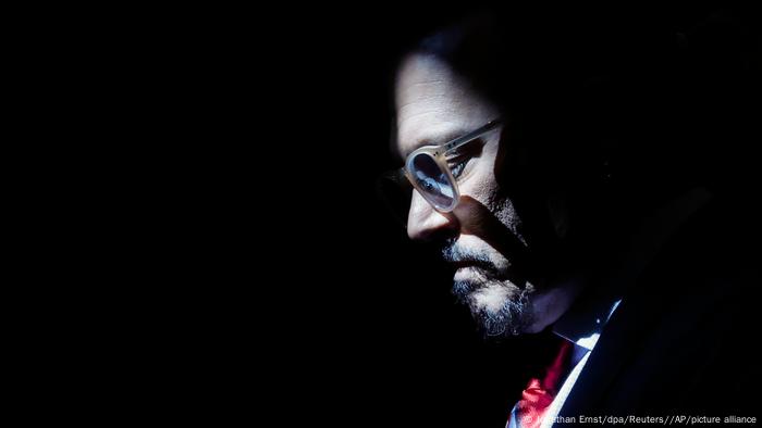 Johnny Depp side profile against black background