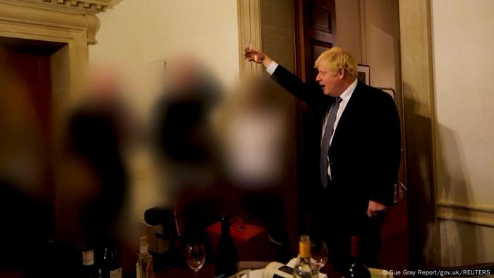 Boris Johnson raising a glass of wine with staffers