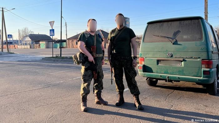 Aleksy (left) poses in military gear with a fellow Ukrainian soldier near Izyum in eastern Ukraine 2022