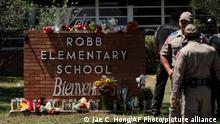 Flowers and candles are placed outside Robb Elementary School in Uvalde, Texas, to honor the victims killed in Tuesday's shooting at the school.