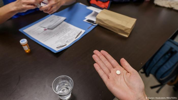A doctor hands a patient the initial abortion inducing medication at a clinic in Oklahoma City on December 6, 2021