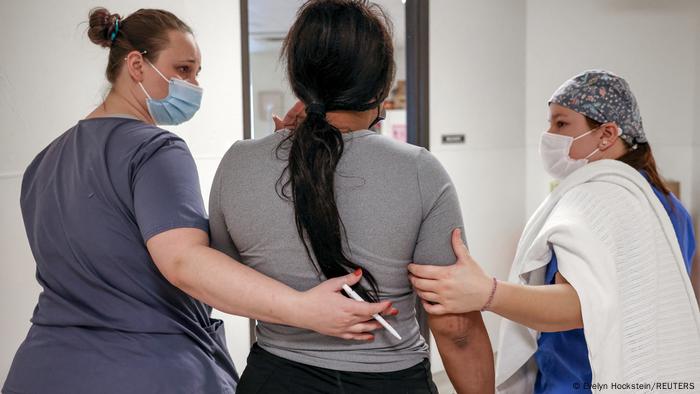 Medical workers walk a Texas patient to the recovery room following her abortion in Oklahoma City on December 6, 2021