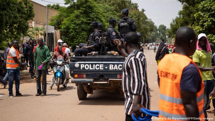 In this July 2021 file photo, police officers ride in a vehicle traveling through Ouagadougou, Burkina Faso