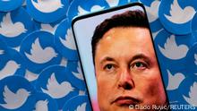 FILE PHOTO: An image of Elon Musk is seen on smartphone placed on printed Twitter logos in this picture illustration taken April 28, 2022. REUTERS/Dado Ruvic/Illustration/File Photo
