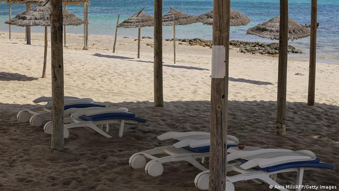 A view of empty sunbeds and shades along a beach in Tunisia's resort town of Hammamet.