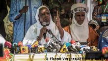 Malian influential imam Mahmoud Dicko (L) speaks during a public meeting in a rare public appearance in Bamako on November 28, 2021. - An influential Malian imam, who spearheaded mass anti-government protests last year, warned on November 28, 2021 that things are not going well in the Sahel state, delivering a rare rebuke to strongman Colonel Assimi Goita. (Photo by FLORENT VERGNES / AFP) (Photo by FLORENT VERGNES/AFP via Getty Images)
