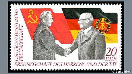 Stamp marking 25 years of German-Soviet friendship - showing a GDR and a Soviet Union flag and Erich Honecker and Leonid Brezhnev shaking hands