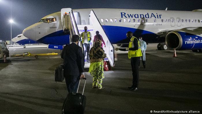 Passengers board a RwandAir flight at Kigali International Airport in Kigali, capital of Rwanda, Aug. 1, 2020