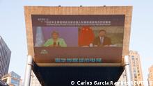 Chinese President Xi Jinping and United Nations High Commissioner for Human Rights Michelle Bachelet are seen on a giant screen broadcasting news footage of their virtual meeting at a shopping complex in Beijing, China May 25, 2022. REUTERS/Carlos Garcia Rawlins