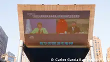 Chinese President Xi Jinping and United Nations High Commissioner for Human Rights Michelle Bachelet are seen on a giant screen broadcasting news footage of their virtual meeting at a shopping complex in Beijing, China May 25, 2022. REUTERS/Carlos Garcia Rawlins