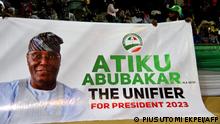 Supporters hold a banner of Nigerian former Vice President Atiku Abubakar during the opposition Peoples Democratic Party's (PDP) primaries in Abuja, on May 28, 2022. - Former Nigerian vice president Atiku Abubakar on May 28, 2022 won the opposition party PDP's primary to choose its candidate for the 2023 presidential election, according to ballot results. (Photo by PIUS UTOMI EKPEI / AFP)