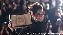 Iranian actress Zar Amir-Ebrahimi poses with her trophy during a photocall after she won the Best Actress Prize for her part in Holy Spider during the closing ceremony of the 75th edition of the Cannes Film Festival in Cannes, southern France, on May 28, 2022. (Photo by LOIC VENANCE / AFP) (Photo by LOIC VENANCE/AFP via Getty Images)