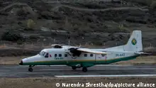 epa05177764 A picture made available on 24 February 2016 shows a twin aircraft of the Tara Airlines landing at Jomsom Airport, in Jomsom, a popular resort town west of Kathmandu, Nepal, 04 April 2015. According to media reports on 24 February 2016, Tara Air Viking 9N-AHH Twin Otter, carrying 20 passenger including one Chinese and one Kuwait national, and three crew members, has been missing while en route to Jomsom from Pokhara. EPA/NARENDRA SHRESTHA ++