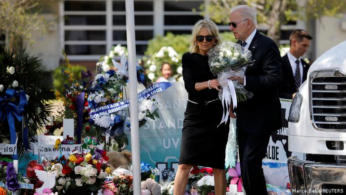U.S. President Joe Biden and first lady Jill Biden hold a bouquet of flowers as they visit the scene of a school mass shooting in Uvalde, Texas, U.S on May 29, 2022