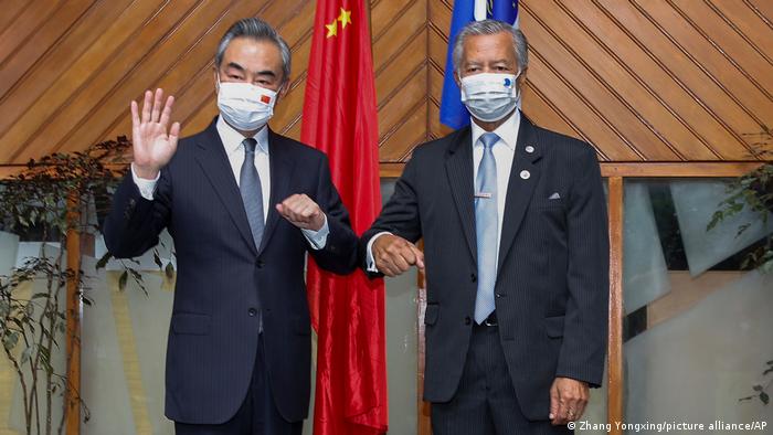 In this photo released by Xinhua News Agency, Secretary-General Pacific Islands Forum Secretariat Henry Puna, right, and visiting Chinese Foreign Minister Wang Yi pose for a photo before their meeting in Suva, Fiji, Sunday, May 29, 2022.
