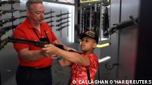 A child holds a firearm on display at the National Rifle Association (NRA) annual convention in Houston, Texas, U.S. May 29, 2022. REUTERS/Callaghan O'Hare