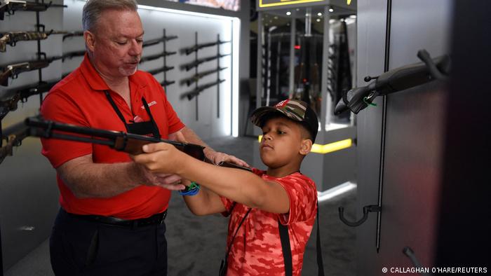 A child holds a firearm at the NRA annual convention in Houston, Texas, on May 29, 2022