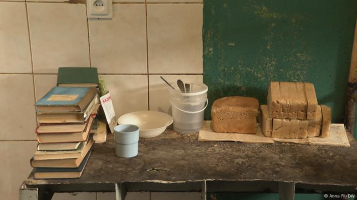 A table with books and bread and cutlery