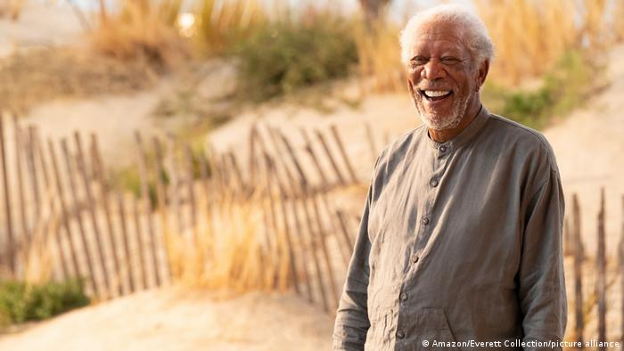 Film still 'Solos' Morgan Freeman smiling in a sandy field.