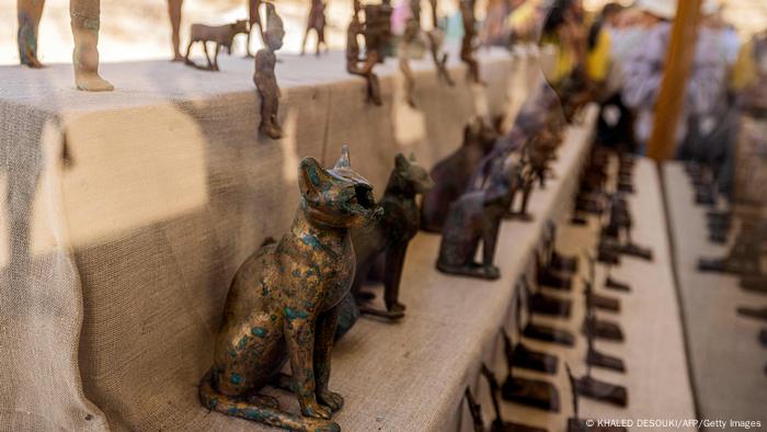 Statuettes and figurines depicting cats and Egyptian deities found in a cache dating to the Egyptian Late Period