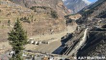 This general view shows state-run NTPC hydropower project site damaged after a broken glacier caused a major river surge that swept away bridges and roads, near Joshimath in Chamoli district of Uttarakhand, on February 7, 2021. - At least 200 people are missing in northern India after a piece of Himalayan glacier fell into a river, causing a torrent that buried two power plants and swept away roads and bridges, police said on February 7. (Photo by Ajay BHATT / AFP)