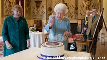 Platinum Jubilee. Queen Elizabeth II cuts a cake to celebrate the start of the Platinum Jubilee during a reception in the Ballroom of Sandringham House, which is the Queen's Norfolk residence. Picture date: Saturday February 5, 2022. The Queen came to the throne 70 years ago this Sunday when, on February 6 1952, the ailing King George VI - who had lung cancer - died at Sandringham in the early hours. See PA story ROYAL Jubilee. Photo credit should read: Joe Giddens/PA Wire URN:65106380