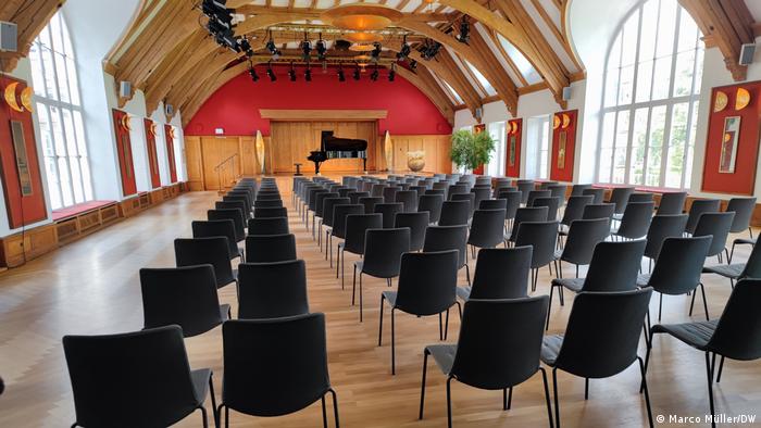The concert hall of Schloss Elmau with chairs lined up as if ready for a concert.