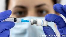 FILE PHOTO: A woman holds a mock-up vial labeled Monkeypox vaccine and medical syringe in this illustration taken, May 25, 2022. REUTERS/Dado Ruvic/Illustration/File Photo