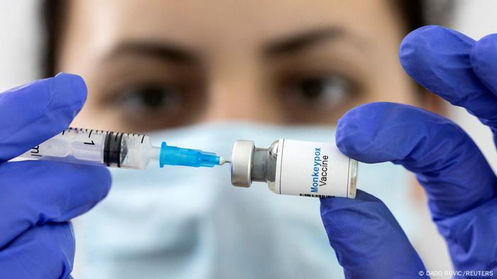 A person draws a monkeypox vaccine dose with a syringe 