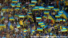 Ukrainian fans support their team before the World Cup 2022 qualifying play-off soccer match between Scotland and Ukraine at Hampden Park stadium in Glasgow, Scotland, Wednesday, June 1, 2022. (AP Photo/Scott Heppell)
