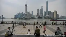 People gather on the Bund along the Huangpu River in Shanghai on June 1, 2022, following the easing of Covid-19 restrictions in the city after a two-month lockdown. (Photo by Hector RETAMAL / AFP)