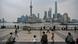 People gather on the Bund along the Huangpu River in Shanghai. People gather on the Bund along the Huangpu River in Shanghai.