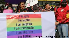 FILE - In this Feb. 12, 2018, file photo, LGBT activists shout slogans during a rally against a planned revision to Indonesia's criminal code that would criminalize unmarried and gay sex outside the Parliament in Jakarta, Indonesia. The death of a 20-year-old man with HIV who died after effectively committed suicide by stopping anti-viral medication is a sign of an out of control but little acknowledged epidemic of HIV among gay men in Indonesia that researchers say is now being fueled by a gay hate climate fostered by the country's conservative political and religious leaders. (AP Photo/Tatan Syuflana, File)