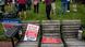 Signs are seen on a bench during a rally against critical race theory. Signs are seen on a bench during a rally against critical race theory.