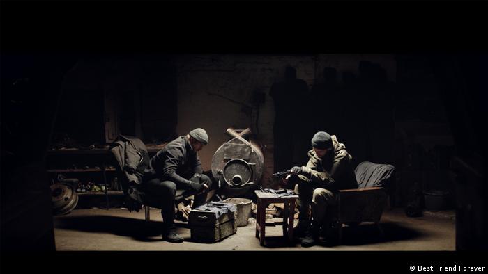 Photo from the film 'Atlantis': Two soldiers seated in a dark space.