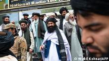 Taliban's minister for refugees in Afghanistan, Khalil Haqqani (C) leaves after attending a ceremony marking the 30th anniversary of the Mujahideen, the 8th of Saur 1371 (28 April 1992) victory over the government of communist regime, in Kabul on April 28, 2022. (Photo by Wakil KOHSAR / AFP)