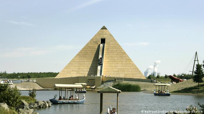Besucher fahren im Freizeitpark Belantis in Leipzig mit Booten von Poseidons Flotte auf einem See vor der nachgebauten 39 Meter hohen Pyramide.