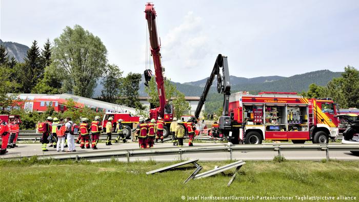Rescue teams and vehicles at the site of a train crash
