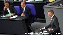 German Economy and Climate Minister Robert Habeck, left, and German Chancellor Olaf Scholz, center, listen to German Finance Minister Christian Lindner, right, as he delivers a speech during a meeting of the German federal parliament, Bundestag, at the Reichstag building in Berlin, Germany, Friday, June 3, 2022. German lawmakers are expected to approve a 100 billion-euro ($107 billion) special fund to strengthen the country's military. (AP Photo/Michael Sohn)