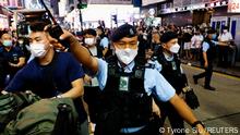 Police officers ask people to leave outside the closed Victoria Park on the 33rd anniversary of the crackdown on pro-democracy demonstrations at Beijing's Tiananmen Square in 1989, in Hong Kong, China, June 4, 2022. REUTERS/Tyrone Siu